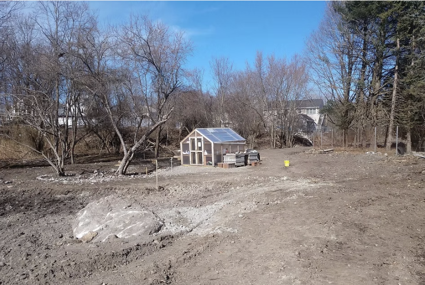 A wide-shot of the vacant plot of land We Grow Microgreens now sits on. Their farm tent is in the middle.